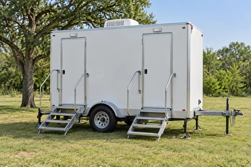 Portable restroom trailer and rails